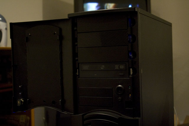 Front closeup of the computer with the front door open. The optical drive, power and reset switch are inside the door.
